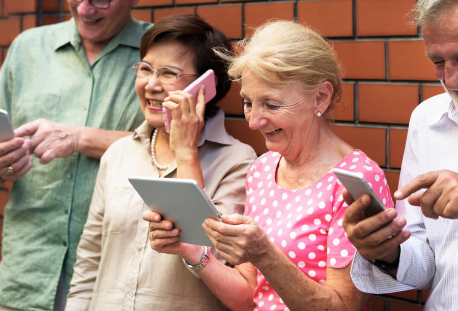 Group Of Diverse Elderly Using Digital Devices